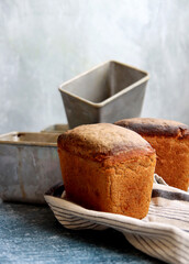 Rectangular bread and aluminum forms on a table. Freshly homemade baked rye bread close up photo. 