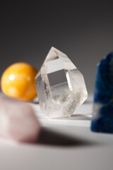 Various healing stone crystals for meditation or spiritual practices on gray background close-up. Vertical orientation