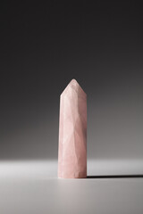 One rose quartz crystal on gray background. Healing minerals, gemstones for relaxation