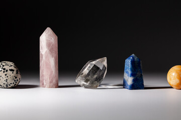 Various healing stone crystals for meditation or spiritual practices on gray background. Horizontal orientation