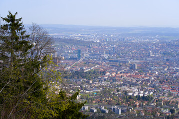 Panoramic view from local mountain Uetliberg over City of Z&uuml;rich on a blue cloudy spring day. Photo taken April 14th, 2022, Zurich, Switzerland.