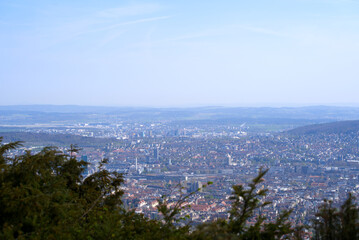 Panoramic view from local mountain Uetliberg over City of Zürich on a blue cloudy spring day. Photo taken April 14th, 2022, Zurich, Switzerland.