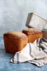 Rectangular bread and aluminum forms on a table. Freshly homemade baked rye bread close up photo. 