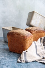 Rectangular sourdough bread on a table. Light grey background with copy space. Healthy eating concept. Rye bread texture close up photo. 