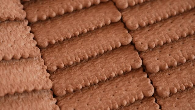 Closeup view 4k stock video footage of tasty crispy brown chocolate biscuits cookies isolated. Abstract food video background