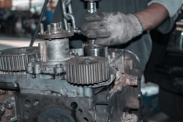 The mechanic is checking the engine.