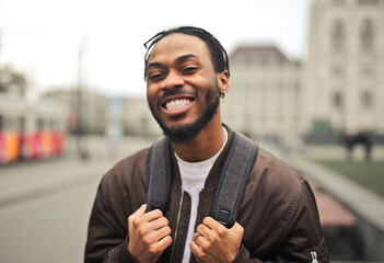 portrait of a smiling young man in the street