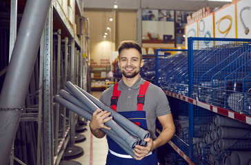 Happy man who works as a salesman at a hardware store where you can buy good quality tools and...