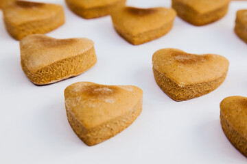 Heart shaped homemade cookies on a white background.
