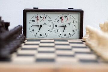 Chess board with chess game being played against white background. Opening game