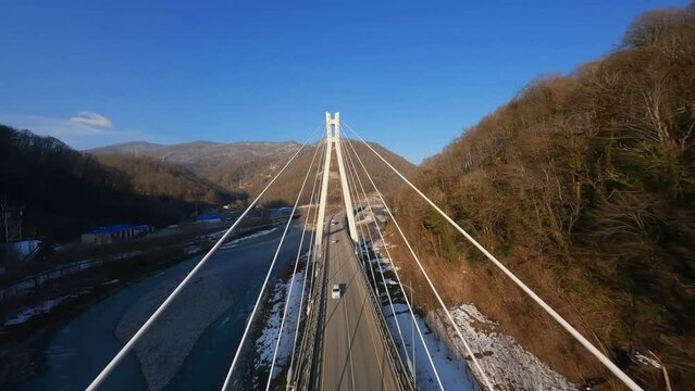 flying above the bridge Following black car on the road on high speed