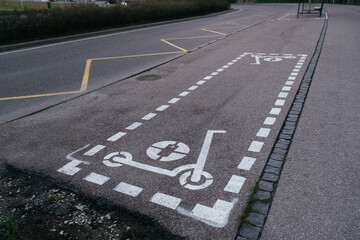 Fototapeta premium Dedicated electric scooter parking spot sign spray painted on city sidewalk. Electric scooters parking area.