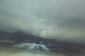 The sun peeps out from behind the dark clouds. A very symbolic photo