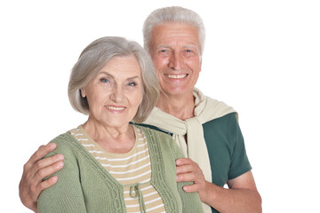 Portrait of happy senior couple embracing on white background