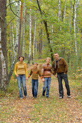 Portrait of family of four in park