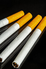 some white and brown cigarettes, cigarettes allowed only for over eighteen, black background