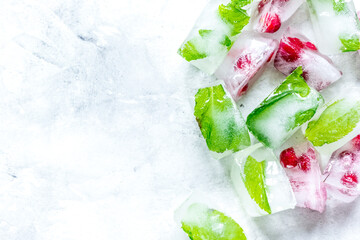 fresh cranberry in ice cubes on gray stone background top view mock-up