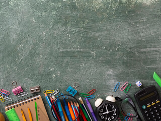 Fototapeta na wymiar School background with school supplies and copy space. Top view, pens and pencils, notebooks, green chalk board