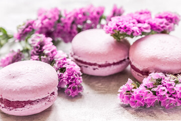 Obraz na płótnie Canvas spring woman breakfast with macaroons and mauve flowers white background