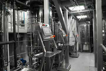 Equipment control station. Factory interior, steel pipelines, tubes. Equipment for the production of organic fertilizers. 