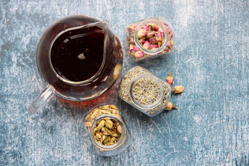 Different tea flavors top view photo. Cinnamon, anise, cardamom, clove, lavender, roses on a table. Aromatic tea close up. Natural antioxidant concept. 
