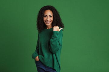 Young black woman laughing while pointing finger aside