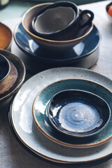 Variety of ceramic tableware, plates, bowls, glazed dishes and cutlery