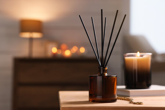 Reed diffuser on wooden table indoors. Space for text