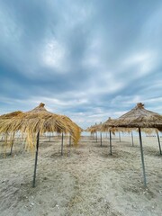 Straw beach umbrellas on a blue sky and sea background.Copy space 