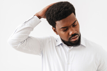 Black mid man wearing shirt posing and holding his head