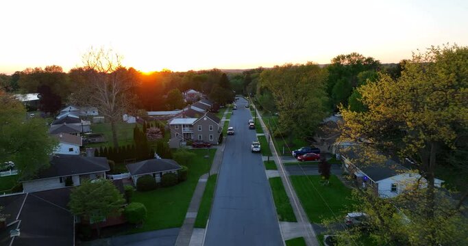 Small Town Neighborhood In Spring. Houses In Residential Area At Sunset. Aerial Establishing Shot.