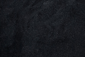 Black sand surface. Black micro gravel or beach sand photo. Granule luxury dark background