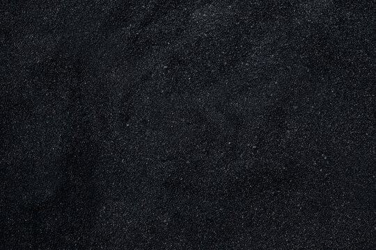 Black sand surface. Black micro gravel or beach sand photo. Granule luxury dark background