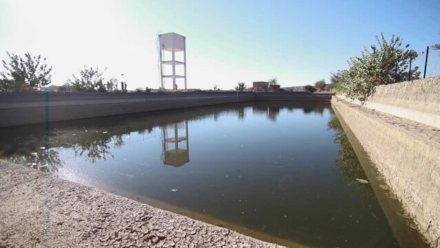 pan left for the water storage facility in the middle of the desert.