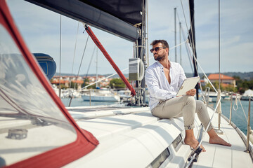 Spontaneous businessman working on the yacht