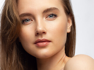 Fototapeta premium Closeup of beauty woman with clean shiny skin and natural cosmetics. Beautiful extrem eyelash and plump lips of a well-groomed girl demonstrate spa procedures, injections in a beauty parlor
