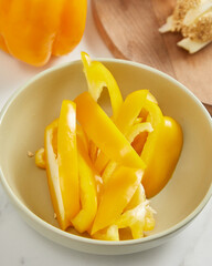 .Fresh whole and sliced sweet yellow pepper. Top view