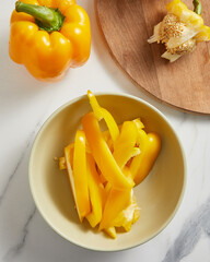 .Fresh whole and sliced sweet yellow pepper. Top view