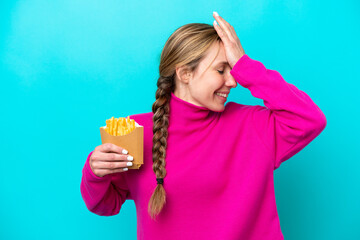 Young caucasian woman holding fried chips isolated on blue background has realized something and intending the solution