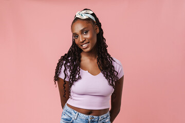 Young black woman wearing headband smiling and looking at camera