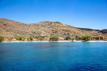 Kythnos island, Greece. Approach Agios Ioannis, sandy empty beach from sea, sunny summer day.