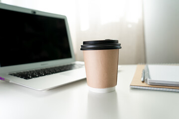 coffee glass on the background of the desktop with a laptop. working atmosphere in the office.