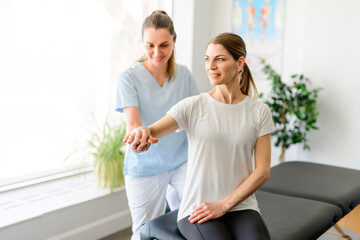 Modern rehabilitation physiotherapy woman worker with woman client
