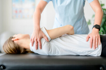 Obraz na płótnie Canvas Modern rehabilitation physiotherapy woman worker with woman client