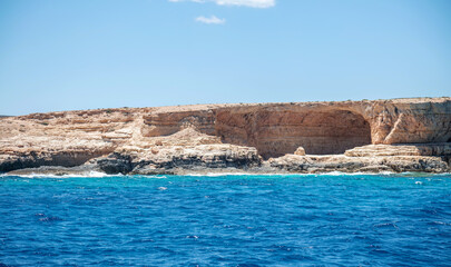 Koufonisi island, Cyclades, Greece. Xilombatis Cave, rocky formation, calm Aegean sea