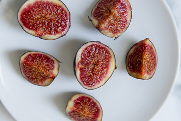 cut figs on a white plate.