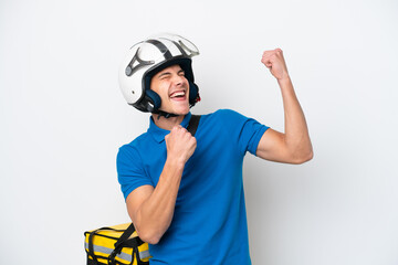Young caucasian man with thermal backpack isolated on white background celebrating a victory