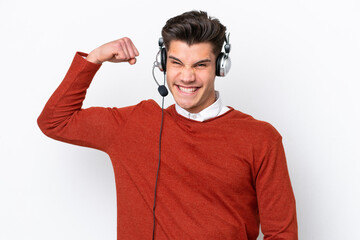 Telemarketer caucasian man working with a headset isolated on white background doing strong gesture