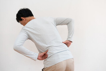 unhappy asian man suffering from backache