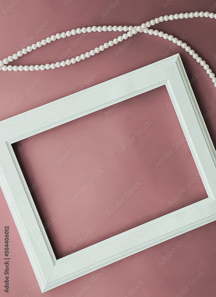 Wall mural Horizontal art frame and pearl jewellery on blush pink background as flatlay design, artwork print or photo album